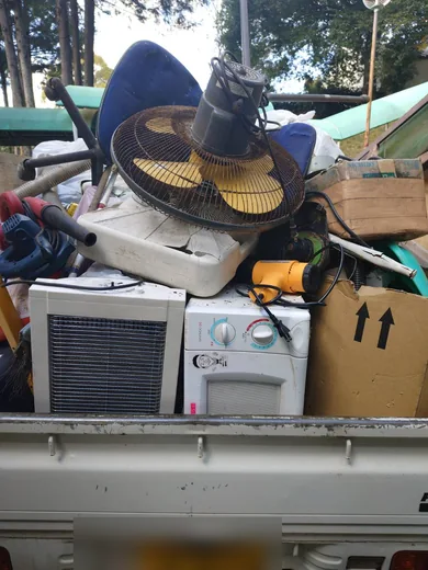 家電や椅子、扇風機などが積まれた荷台
